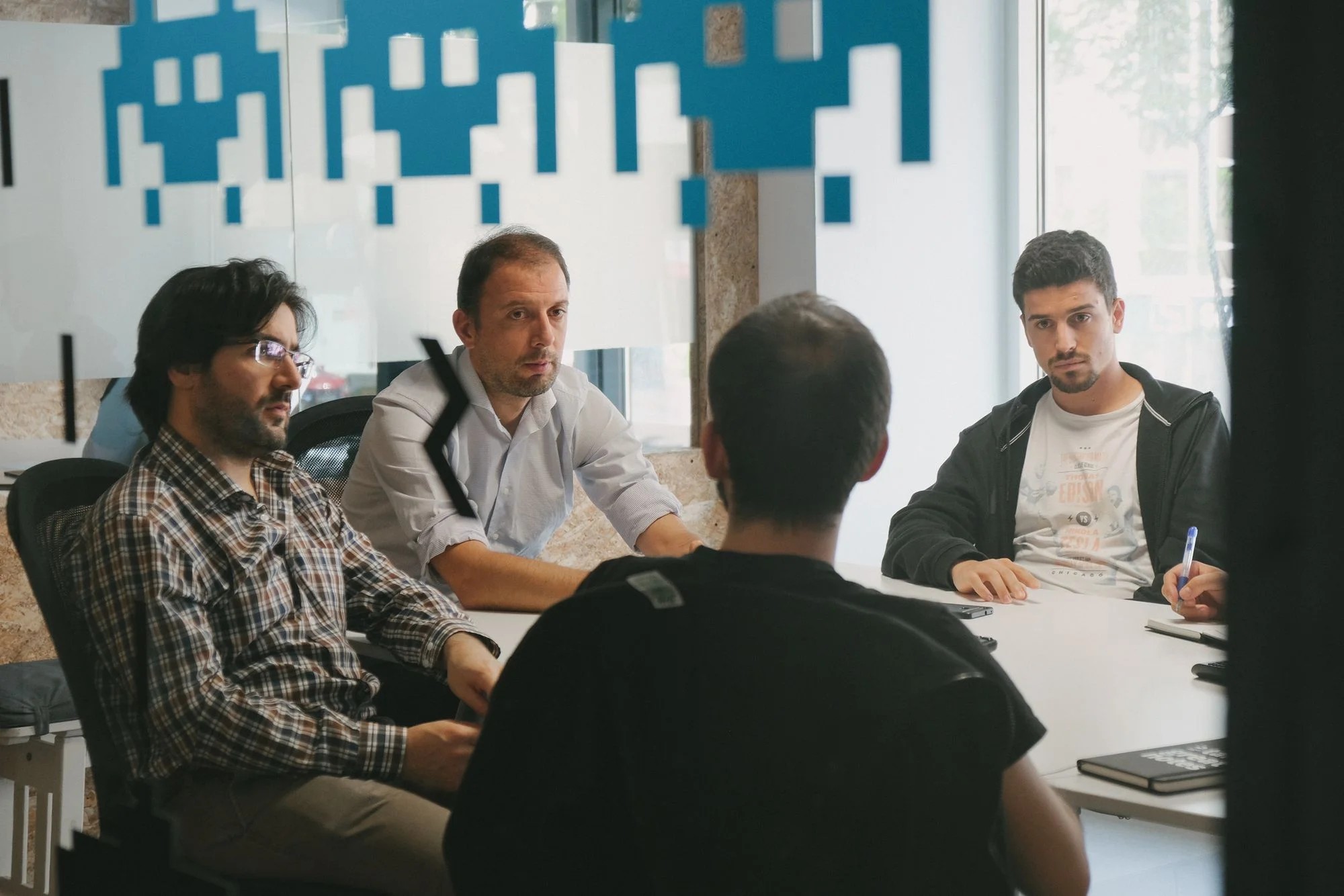 Group of young people working together and focusing on solving programming problems at Premium Minds' office